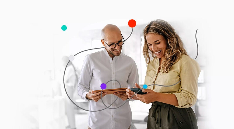 two people holding mobile devices and working together two people holding mobile devices and working together